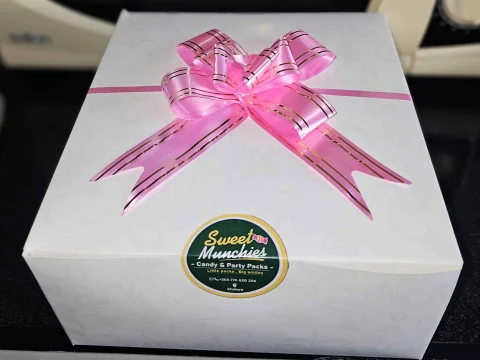Premium birthday gift box opened, showing chocolates and sweets